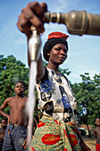 Woman pours water from faucet, Malawi
