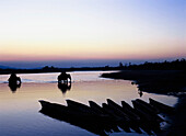 Boats and elephants on Ratpi River at sunset, Chitwan Park, Nepal