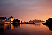 Skyline of town at dusk, Alesund, Norway