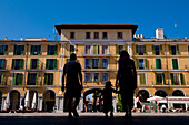Silhouette of family walking into Plaza Mayor, rear view, Palma de Majorca, Majorca, Ballearic Islands, Spain