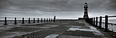 Fisherman on end of Roker pier beside lighthouse, Sunderland, Tyne & Wear, UK