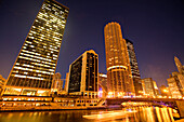 Skyscrapers along Chicago River at night, Chicago, Illinois, USA