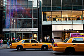 Taxis Passing By Some Designer Shops In 5Th Avenue, Midtown Manhattan, New York, USA