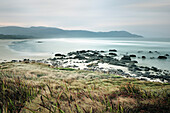 Beach with rocks and mountains, Cloudy Bay, Bruny Island, Tasmania, Australia