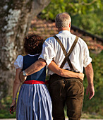 Couple arm in arm, Chieming, lake Chiemsee, Chiemgau, Upper Bavaria, Germany