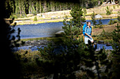 Young woman hiking through the wonderful nature in the Tioga Pass area, Yosemite National Park, California, USA