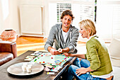 Young couple playing monopoly, Hamburg, Germany