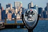 Coin-operated binocular viewer installed at the Statue of Liberty overviewing Lower Manhattan, New York, USA