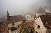 France, Midi-Pyrenees Region, Lot Department, St-Cirq-Lapopie, town overview in fog
