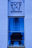 France, Paris, Eiffel Tower reflected in the Palais de Challiot windows, dawn