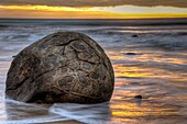 Moeraki boulders at dawn as SW front passes overhead, near Oamaru, Otago