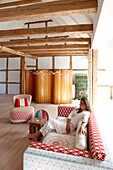 Woman sitting on a sofa inside a hotel suite, Fincken, Mecklenburg-Western Pomerania, Germany