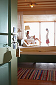 Woman and girl in a hotel room, door with room key in foreground, Am Hochpillberg, Schwaz, Tyrol, Austria