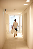 Man walking along a hallway in spa area of a hotel, Ramatuelle, Provence-Alpes-Cote d'zur, France