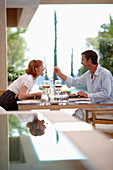 Couple having lunch in outdoor area of a hotel restaurant, Ramatuelle, Provence-Alpes-Cote d'Azur, France