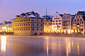 Illuminated city hall with river Limmat in foreground, Zurich, Switzerland