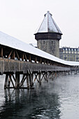 Chapel Bridge, Kapellbruecke with water tower, Wasserturm and covered wooden bridge above river Reuss, Lucerne, Switzerland