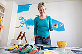 Mother painting the wall of the childrens bedroom, MR, Leipzig, Sachsen, Germany