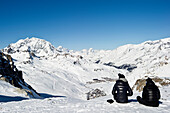 Two people having a rest and enjoying the view, Tignes, Val d Isere, Savoie department, Rhone-Alpes, France