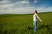 Girl standing in a meadow, Upper Bavaria, Germany