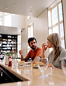 Guests eating chips, fries in the restaurant of the Lloyd Hotel, Zeeburg, Amsterdam, Netherlands