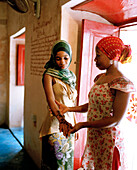Therapist Acha with client shows henna painting at Mrembo Spa, Mrembo means beautiful woman, old house in the center of Stone Town, Zanzibar, Tanzania, East Africa