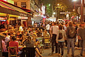 People in the street and in restaurants in the evening, La Porte Montmartre, Boulevard Montmartre, Paris, France, Europe