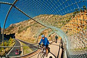 Bicycling on a bridge over Interstate 70 on the Glenwood Canyon Bicycle Path, Glenwood Springs, Colorado USA