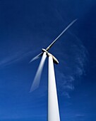 A single wind turbine set against a blue sky at the Gilfach Goch Wind Farm near Bridgend and Pontypridd, Mid Glamorgan, Wales, United Kingdom