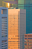 A telephoto view captures a tight cluster of skyscrapers rising from the Shiodome business complex near the Shimbashi District of central Tokyo, Japan.