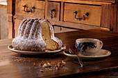'France, 68, Kougelhopf sprinkled sugar on a wooden table ''pastry'''