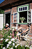 Family at dinner in a garden, Klein Thurow, Roggendorf, Mecklenburg-Western Pomerania, Germany