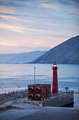 Birds on pier and lighthouse at dusk, Iquique, Tarapaca, Chile, South America