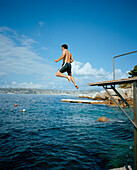 Man jumping into the sea, area of Hotel du Cap-Eden-Roc Boulevard JF Kennedy, BP 29, 06601 Antibes Cedex, Cote d'Azur, France, Europe