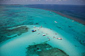 Luftaufnahme von Ausflugsbooten sowie badenden und mit Rochen schnorchelnden Menschen im kristallklaren Wasser an der Stingray City Sandbank, Grand Cayman, Kaimaninseln (Cayman-Inseln), Karibik