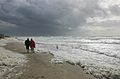 People walking along a stormy beach, Sylt, North Sea Coast, Schleswig Holstein, Germany