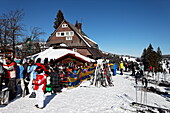 People in front of ski hut Hexenhuesli, Grafenmatt, Feldberg skiing region, Black Forest Baden Wurttemberg, Germany, Europe