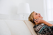 Woman on sofa talking on cell phone