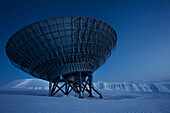 Satellite dish in snow_covered field. Satellite dish in snow_covered field