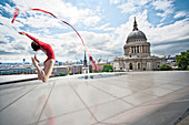 Dancer with ribbon on urban rooftop. Dancer with ribbon on urban rooftop