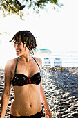 Woman standing in shower at beach. Woman standing in shower at beach