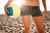 Woman holding volleyball on beach. Woman holding volleyball on beach