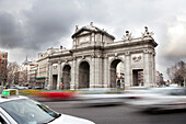 Time lapse view of traffic in city. Puerta de Alcala, Arch, Gateway, Madrid, Spain