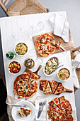 Overhead view of table with pizzas. 090227Pizza
