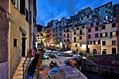City scene with colorful buildings at dusk in Manarola along the Cinque Terre coast in Italy