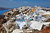 Overall hillside view of structures in the village of Oia in Santorini, Greece