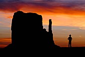 A Cowboy watches the sunset over the Mittens in Monument Valley on the southern border of Utah with northern Arizona  The valley lies within the range of the Navajo Nation Reservation  The Navajo name for the valley is Tsé Bii´ Ndzisgaii - Valley of the R