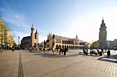 Carriages, The Cloth Hall, St Mary the Virgin Basilica and Town Hall at Main Market Square, Krakow, Poland, Europe