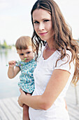 Young mother holding daughter, Old Danube, Vienna, Austria