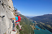 Young man climbing fixed rope route Rino Pisetta, Lago die Toblino, Sarche, Calavino, Trentino, Trentino-Alto Adige, Suedtirol, Italy